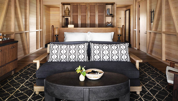 A sitting area and bed in one of the resort's bungalows. A sitting area and bed in one of the resort's bungalows.