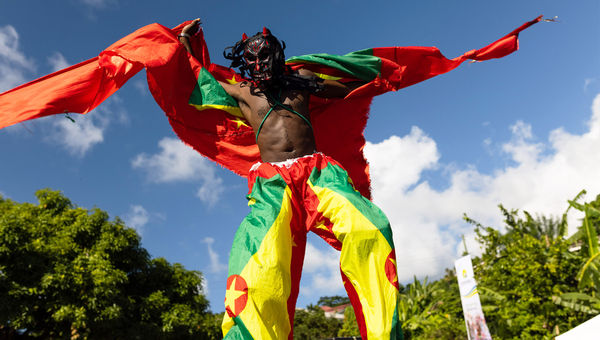 A stilt walker takes part in Grenada’s 2022 Spicemas festival. A stilt walker takes part in Grenada’s 2022 Spicemas festival.