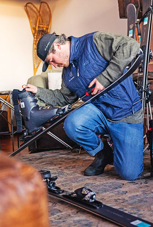 A technician with Ski Butlers works on skis. A technician with Ski Butlers works on skis.
