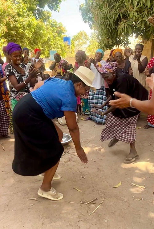 Nicole Edenedo motions her hand to sweep her feet during a welcome drum and dance circle. Nicole Edenedo motions her hand to sweep her feet during a welcome drum and dance circle.